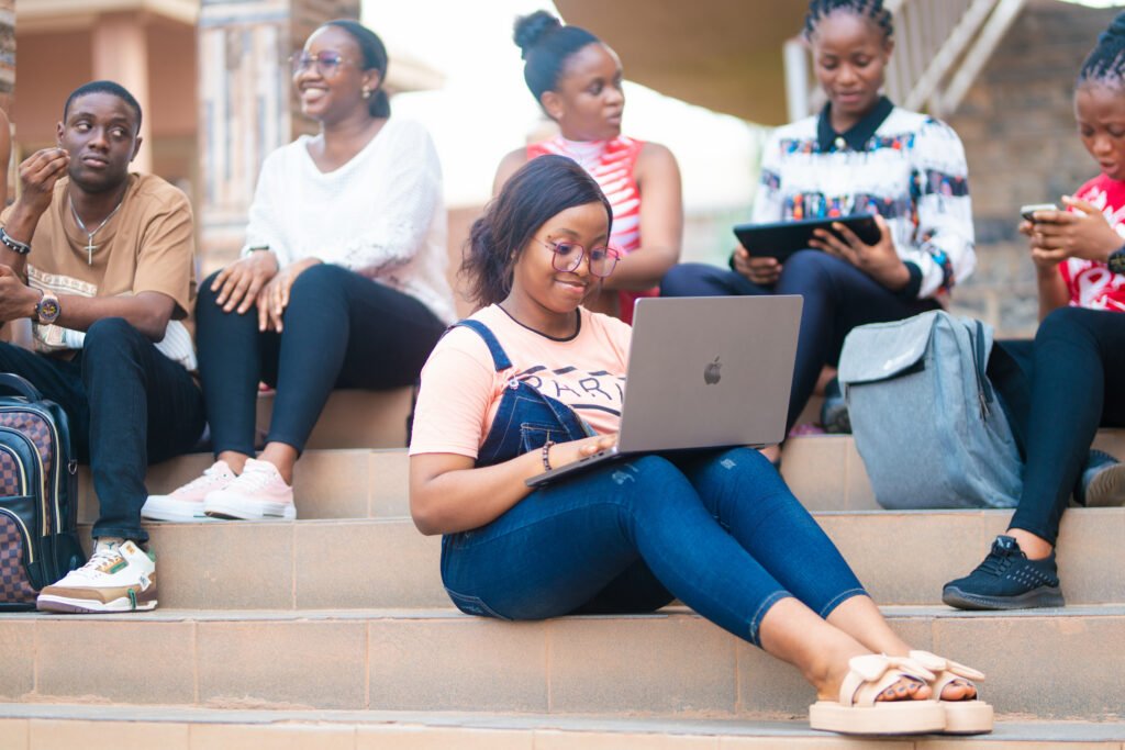 Shanahan University students studying together with laptops on the campus steps
