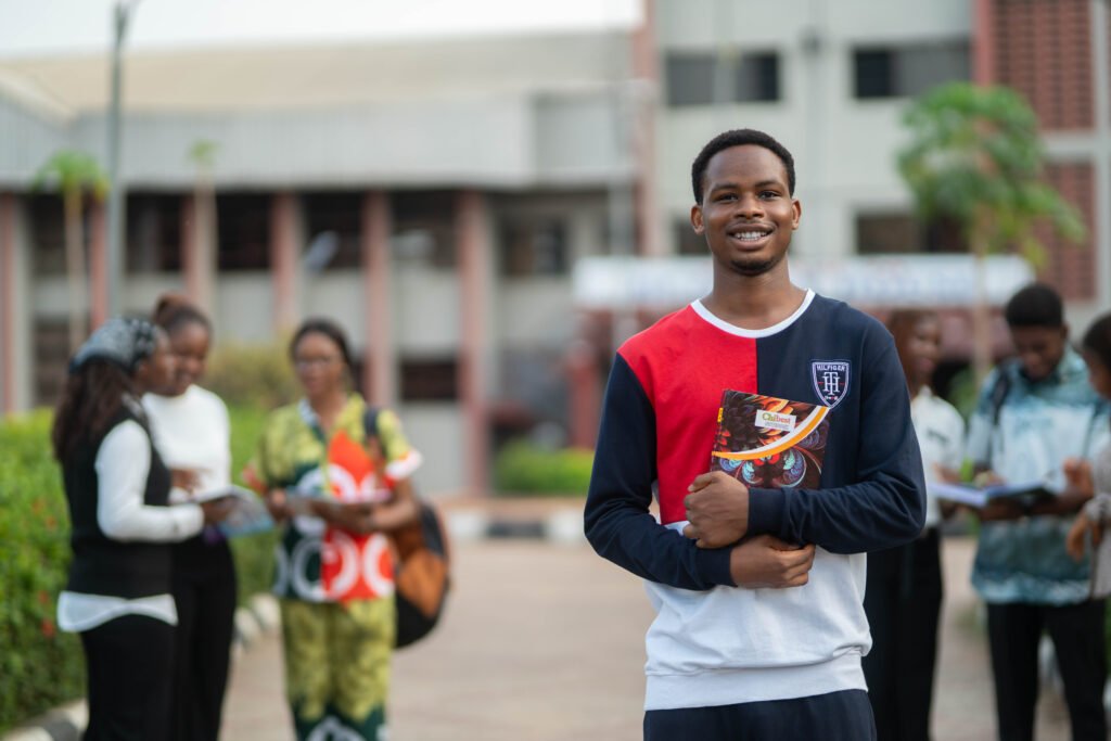 A Shanahan University student standing in front of the university building