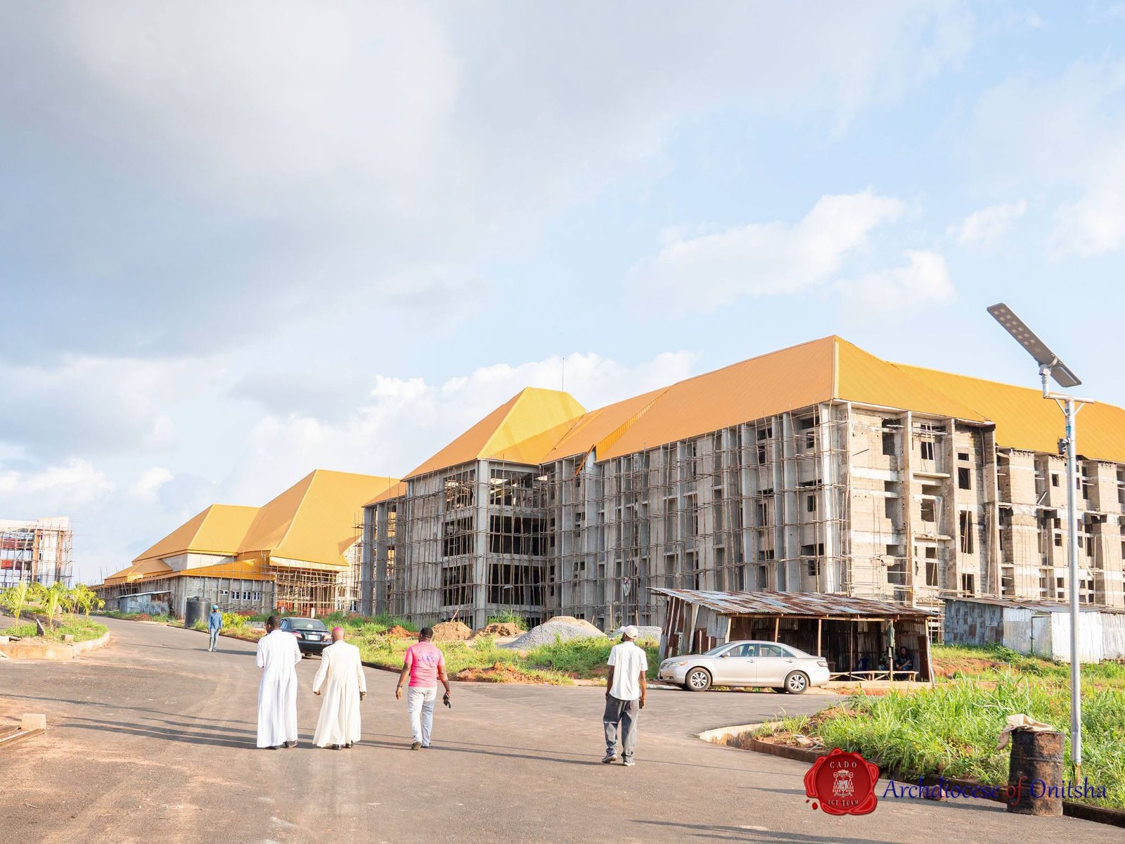 Panoramic view of the Shanahan University permanent site, Onitsha, with its golden-roofed academic buildings under construction