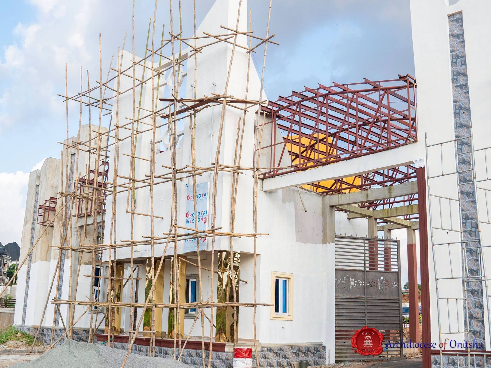 University gatehouse under construction with steel roof framing at Shanahan University Onitsha