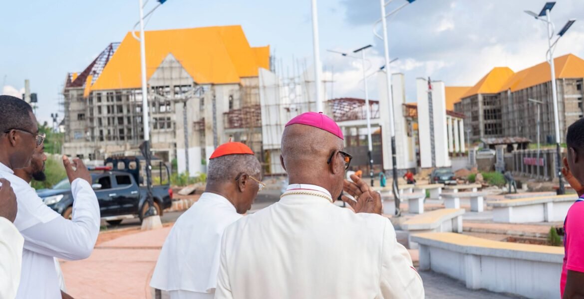 Clergy walking through the campus plaza with solar street lights during the site tour