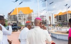 Clergy walking through the campus plaza with solar street lights during the site tour