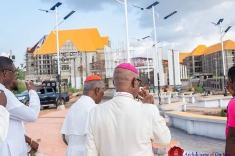 Clergy walking through the campus plaza with solar street lights during the site tour