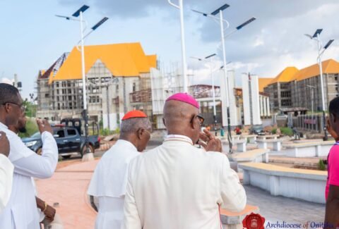 Clergy walking through the campus plaza with solar street lights during the site tour