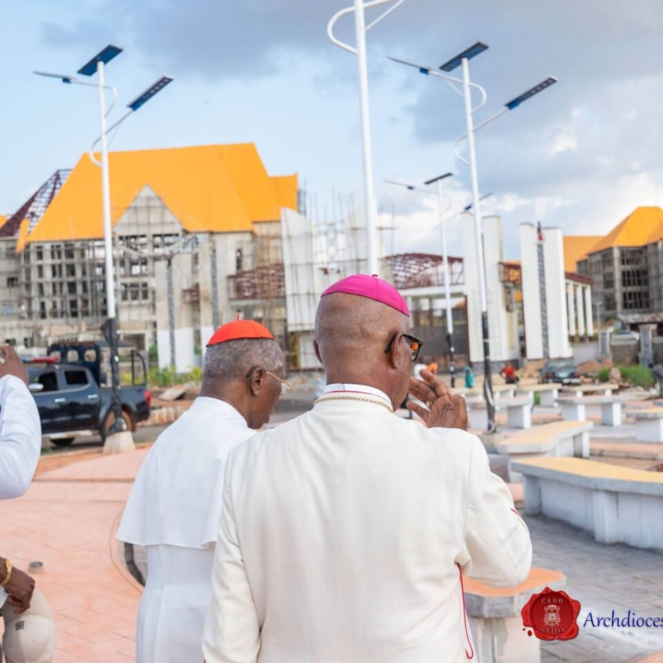 Clergy walking through the campus plaza with solar street lights during the site tour
