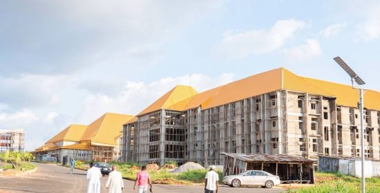 Panoramic view of the Shanahan University permanent site, Onitsha, with its golden-roofed academic buildings under construction
